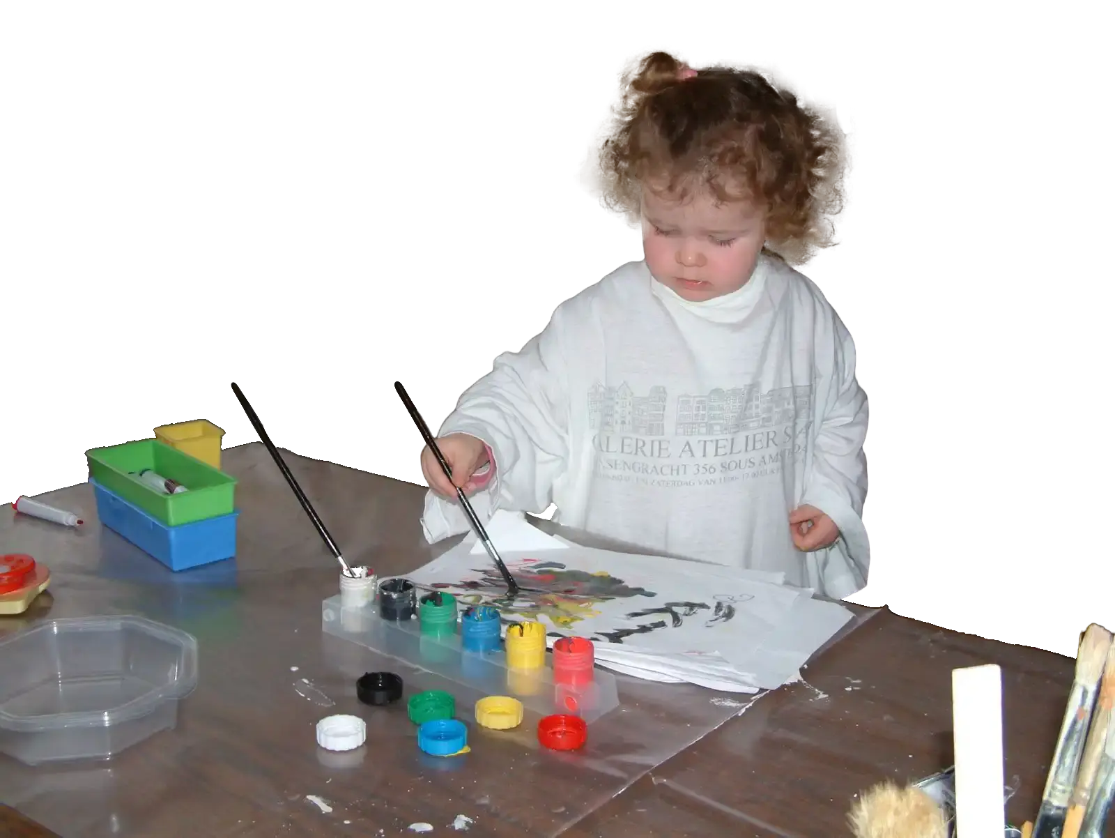Young Donna creating something at a desk